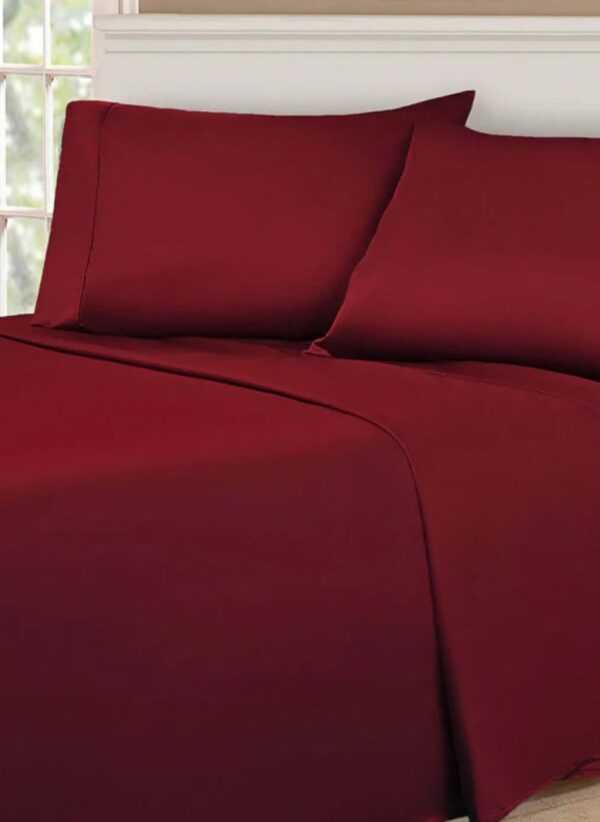 Egyptian Cotton 530 Thread Count Solid Deep Pocket Bed Sheet Set – A neatly spread bed showcasing luxurious, smooth sheets in a rich, solid color